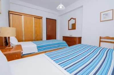 a bedroom with two beds and a dresser and a bed sidx sidx sidx sidx at Galé Catia by Innkeeper in Guia