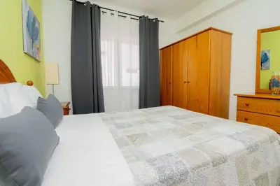 a bedroom with a bed and a dresser and a window at Galé Catia by Innkeeper in Guia