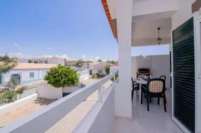a balcony with a table and chairs on it at Galé Igor by Innkeeper in Guia