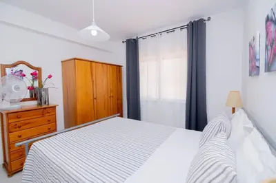 a bedroom with a bed and a dresser and a window at Galé Magda by Innkeeper in Guia