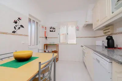 a kitchen with a yellow bowl on a wooden table at Galé Magda by Innkeeper in Guia