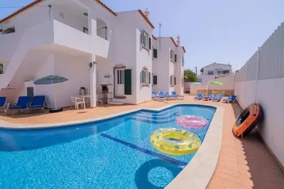 a pool in front of a villa with a swimming pool at Galé Magda by Innkeeper in Guia