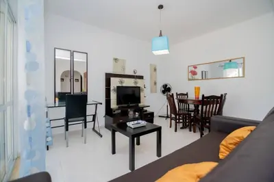 a living room with a couch and a table at Galé Magda by Innkeeper in Guia