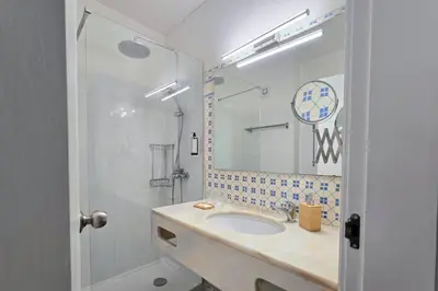 a bathroom with a sink and a shower at Beach House on Faro Island with a Dreamy Terrace and 7 Beds for the Perfect Escape in Faro