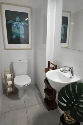 a bathroom with a toilet and a sink at Beach House on Faro Island with a Dreamy Terrace and 7 Beds for the Perfect Escape in Faro