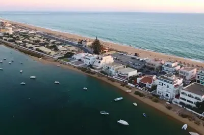 an aerial view of a beach with houses and boats at Beach House on Faro Island with a Dreamy Terrace and 7 Beds for the Perfect Escape in Faro