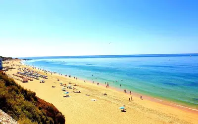 a beach with a bunch of people on the water at Corte Real Apartment AE - Sea & Old Town View in Albufeira