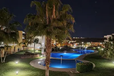 a balcony with wicker chairs and a couch at Superbe Paradis dans les Jardins de la Marina in Albufeira