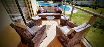 a balcony with a couch and chairs and a table at Superbe Paradis dans les Jardins de la Marina in Albufeira