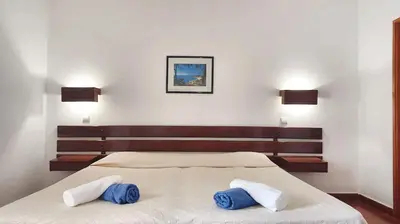 a bedroom with a bed with two pillows on it at Bright apartment with sea view in Albufeira - 67 m² + pool in Albufeira