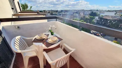 a table and chairs on a balcony with a view at Bright apartment with sea view in Albufeira - 67 m² + pool in Albufeira