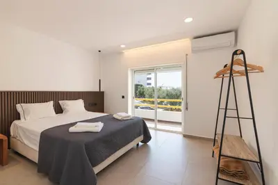 a bedroom with a bed and a ladder and a window at Apartamento em Albufeira - Condomínio com Piscina in Albufeira