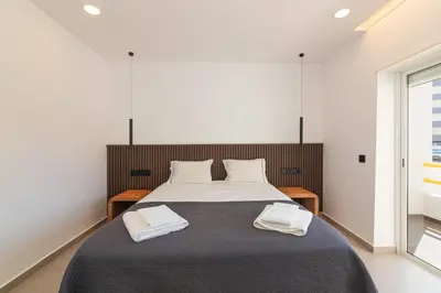 a bedroom with a bed with two towels on it at Apartamento em Albufeira - Condomínio com Piscina in Albufeira