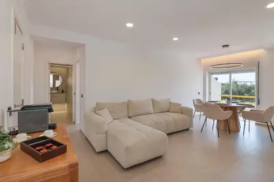 a living room with a couch and a table at Apartamento em Albufeira - Condomínio com Piscina in Albufeira