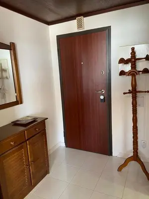 a room with a wooden door and a wooden dresser at Quarteira-Mar in Quarteira