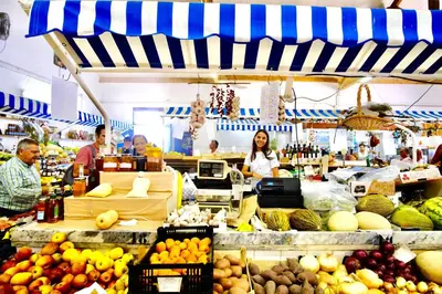 a group of people in a market with fruits and vegetables at Central Algarve Duplex Retreat with Garden & Pool in Quarteira