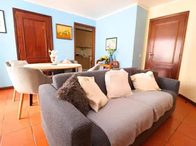 a living room with a couch and a table at Vilamoura Marina Apartment by Stay ici Algarve Holiday Rental in Quarteira