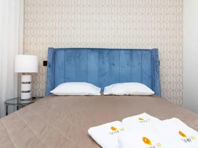 a bed with two pillows and a blue head board at Sea la Vie House by Stay ici Algarve Holiday Rental in Albufeira