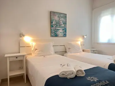 a bedroom with two beds with towels on them at Gardens Dubai by FHR in Vilamoura