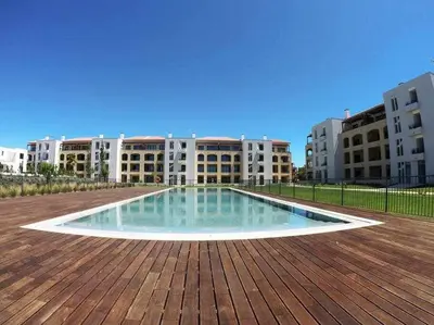 a swimming pool in the middle of a building at Gardens Dubai by FHR in Vilamoura