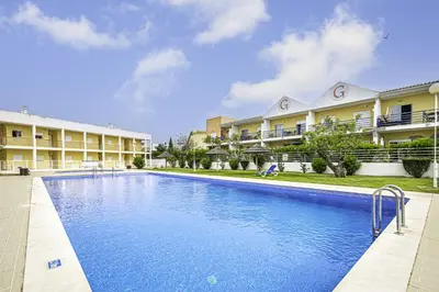 a swimming pool in front of some apartment buildings at BeGuest Summer Breeze in Vale Parra in Galé