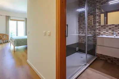 a bathroom with a shower and a sink at Villa ENCOSTA VISTA SALGADOS - BY BEDZY in Guia