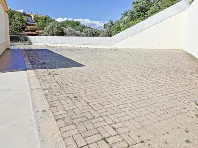 a brick walkway next to a white wall at Villa ENCOSTA VISTA SALGADOS - BY BEDZY in Guia