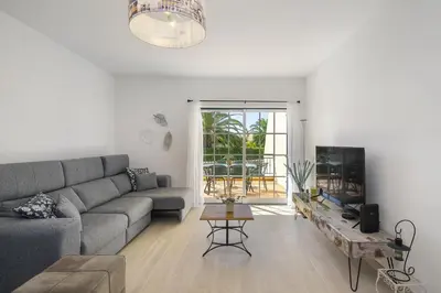 a living room with a couch and a table at Rosal Beach House in Albufeira