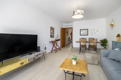 a living room with a large flat screen tv at Rosal Beach House in Albufeira