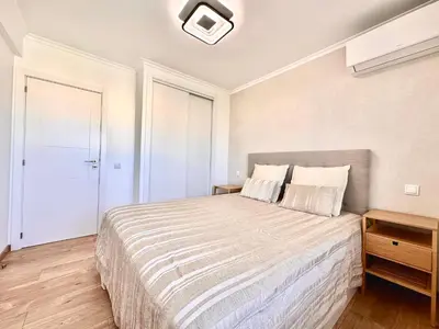 a bedroom with a large bed in a room at Holiday Apartment Albufeira in Albufeira