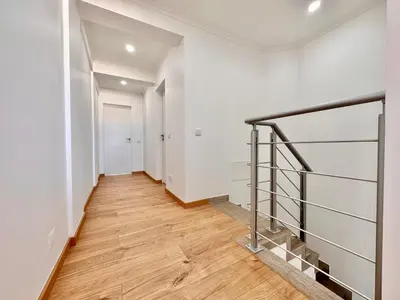 an empty hallway with white walls and wooden floors at Holiday Apartment Albufeira in Albufeira
