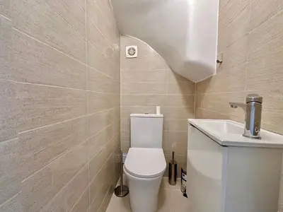 a small bathroom with a toilet and a sink at Holiday Apartment Albufeira in Albufeira