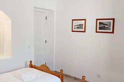 a bedroom with a bed and two pictures on the wall at Casa Solar in Guia
