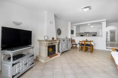 a living room with a fireplace and a flat screen tv at Casa Solar in Guia
