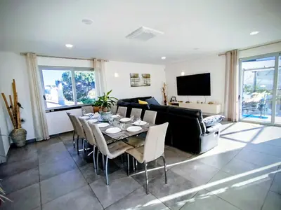 a living room with a table and a couch at Villa Luz 37 - Jacuzzi Terrace & Swimming Pool in Albufeira
