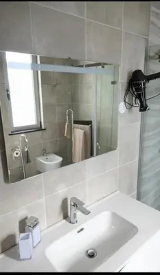 a bathroom with a sink and a mirror at Villa Luz 37 - Jacuzzi Terrace & Swimming Pool in Albufeira