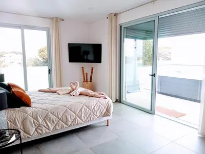 a bedroom with a bed and a sliding glass door at Villa Luz 37 - Jacuzzi Terrace & Swimming Pool in Albufeira