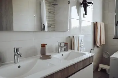 a white bathroom with a sink and a mirror at Villa Luz 37 - Jacuzzi Terrace & Swimming Pool in Albufeira