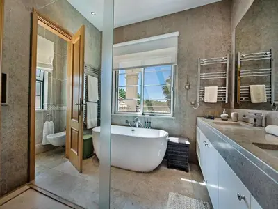 a large bathroom with a large tub and a sink at Exquisite Quinta Da Lago Villa Villa Majestic Heights 4 Bedrooms in Almancil