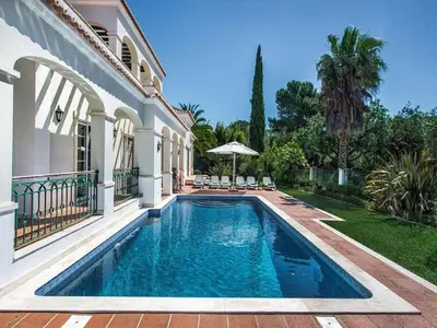 a swimming pool in the backyard of a house at Exquisite Quinta Da Lago Villa Villa Majestic Heights 4 Bedrooms in Almancil