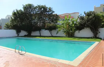 a swimming pool in front of a building at Casa Oura Sea Living in Albufeira