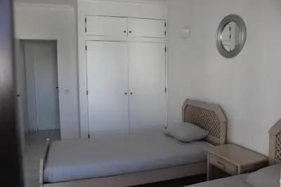 a small bedroom with a bed and a mirror at Casa Oura Sea Living in Albufeira