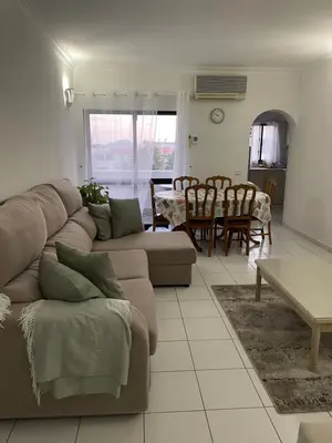 a living room with a couch and a table at Casa Oura Sea Living in Albufeira
