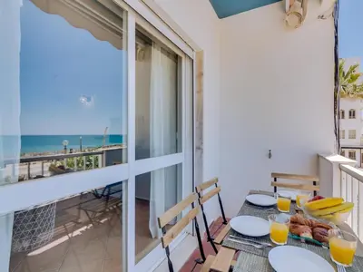 a dining table with a view of the ocean at AL - Apartamento Maré Baixa in Quarteira