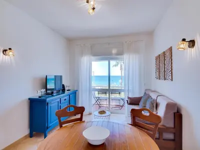 a living room with a couch and a table and a television at AL - Apartamento Maré Baixa in Quarteira