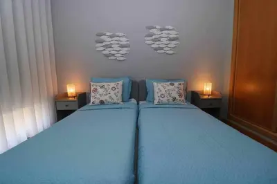 a bedroom with two blue beds and two lamps at Millennium golf by FHR piscina & parking in Vilamoura