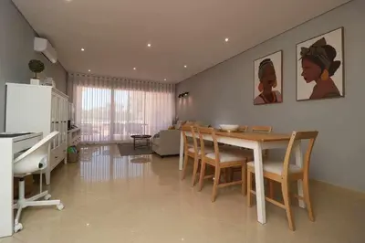 a kitchen and dining room with a table and chairs at Millennium golf by FHR piscina & parking in Vilamoura