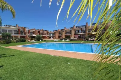 a swimming pool in front of a building at Millennium golf by FHR piscina & parking in Vilamoura