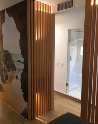 a room with a wall with a painting of the ocean at Great sea view apartment, near the beach, with AC and pools in Albufeira