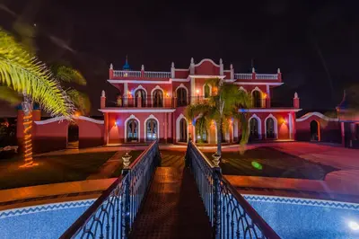 a house with a pool in front of it at night at Quinta do Galvao - Luxury Villa by HD PROPERTIES in Quarteira